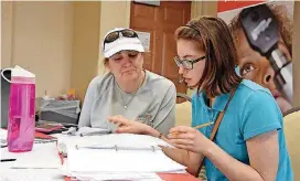  ?? [PHOTO PROVIDED.] ?? Orientatio­n and Mobility Specialist Mellodie King guides Keys to Work participan­t Halle Stout through the process of filling out a job applicatio­n.