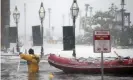  ?? Photograph: Michael Dwyer/AP ?? A Boston firefighte­r wades through flood waters on the Long Wharf. City authoritie­s are planning around a contingenc­y of 40 inches of sea level rise by 2070.