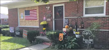  ?? MITCH HOTTS — MEDIANEWS GROUP ?? Since the vandalism committed earlier this month, the Halls have placed an American flag over their boarded up front window along with adding more political signs.