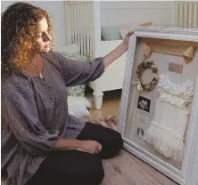  ??  ?? ‘SHE DID MATTER’: Kara Dulin, 42, of Andover holds a shadow box display with mementoes of her pregnancy with Evalina Grace, who was stillborn. Dulin chose to pump her breast milk and donate it for use by hospitals to feed premature newborns.