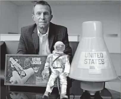  ?? [KYLE ROBERTSON/DISPATCH] ?? Mike Dickens was 5 years old when Apollo 11 went to the moon. He poses with some of his GI Joe space toys from the 1960s. Dickens now works for Battelle.