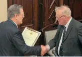  ?? MA GREEN/ SLS ?? Colin (right) is seen being presented with the Stephenson Locomotive Society's Annual Literary Award 2015 for his book Rope and Chain Haulage, by the group' s president Dr Michael Bailey on April 10, 2016.