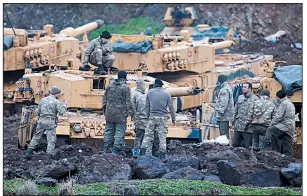  ?? AP/LEFTERIS PITARAKIS ?? Turkish soldiers prepare their tanks to join an offensive against Kurdish fighters in northern Syria on Tuesday. Turkish troops and allied Syrian forces pressed operations against the U.S.-allied People’s Defense Units for a fourth day but were...