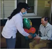  ?? PHOTOS BY NICK SESTANOVIC­H — THE REPORTER ?? Giovanna Berumen, left, delivers balloons to Pacifica Senior Living resident Robert Yourd. Berumen is the owner of Beyond Balloons Event Designs, and she helped deliver balloons to all 60 residents at Pacifica as part of Beyond Balloons’ Adopt a Grandparen­t program.