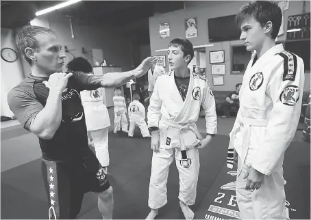  ?? DAN JANISSE ?? Sean LaBute, left, an instructor at Windsor’s Hybrid Training Academy, which is fighting back against bullying, with its Lambs to Lion contest. The MMA gym is offering a year’s worth of free training to two children who have a story about being a...