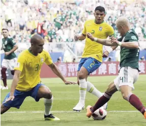  ?? AP ?? Brazil’s Thiago Silva (centre) and Miranda (left) move in to tackle Mexico’s Javier Hernández during the roundof-16 match between Brazil and Mexico on Monday.