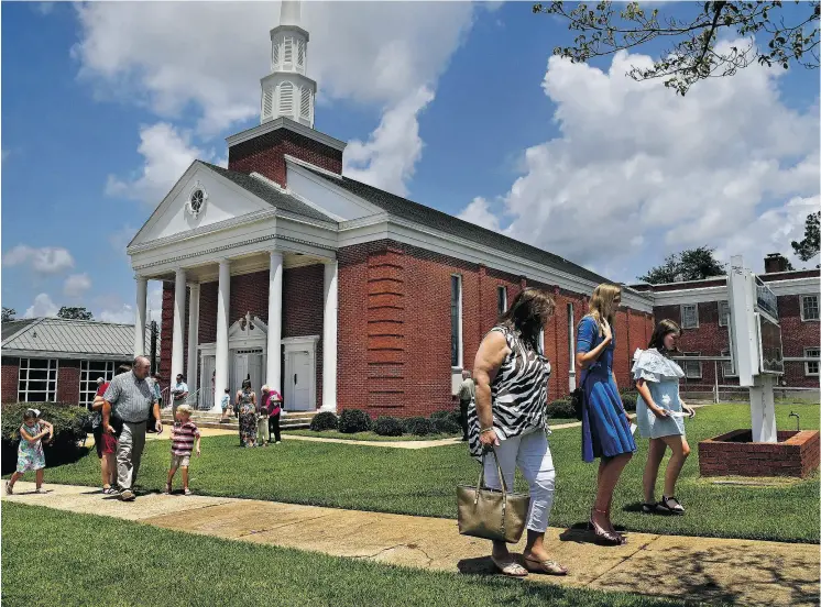  ?? PHOTOS: MICHAEL S. WILLIAMSON / THE WASHINGTON POST ?? Congregant­s leave the First Baptist Church in Luverne, Ala., after Sunday service. All over the Bible Belt, support for President Donald Trump was rising among Christian voters.