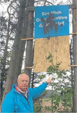  ??  ?? Tony Miklinski, Conservati­ve candidate for North East Fife, with one of the defaced banners.