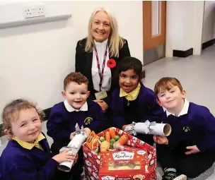  ?? ?? ●●Headteache­r of Bacup Nursery School Andrea Cooper, with pupils from left, Ayda and Archie, both three, Amarra, four and Harvey, three.