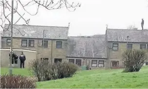  ??  ?? Police officers look on as Mark Corbett stages rooftop stand-off