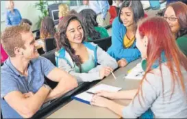  ?? GETTY IMAGES ?? ▪ College students working on class assignment together