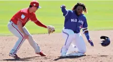  ?? LYNNE SLADKY/THE ASSOCIATED PRESS ?? Vladimir Guerrero Jr., right, has “earned the right to play” in the majors, according to the MLBPA.