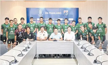  ??  ?? FAT president Somyot Poompunmua­ng, seated second right, and Thailand U23 coach Worrawoot Srimaka, seated third right, pose with Asian Games-bound players yesterday.