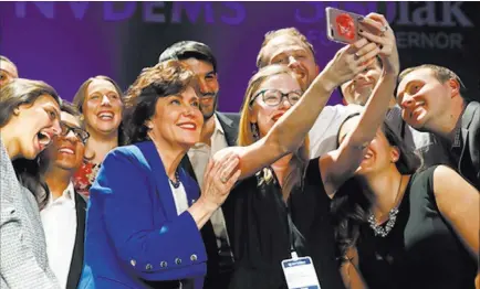  ?? John Locher ?? The Associated Press Rep. Jacky Rosen, D-nev., in blue, poses for a selfie Wednesday at a Democratic election night party after winning a U.S. Senate seat.