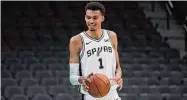  ?? Eric Gay/Associated Press ?? San Antonio Spurs first round draft pick Victor Wembanyama handles the ball following an introducto­ry news conference Saturday in San Antonio.