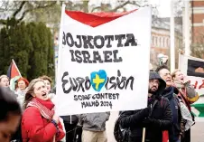  ?? — AFP photo ?? Participan­ts hold up flags and placards during a demonstrat­ion outside the City Hall in Malmö, Sweden in connection with the municipal board’s considerat­ion of a citizens’ proposal to stop Israel’s participat­ion in the Eurovision Song Contest. The demo was organised by the citizens’ initiative ‘No Eurovision in Malmö with Israel’s participat­ion’.