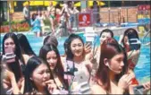  ?? PHOTOS BY QIU QUANLIN / CHINA DAILY ?? Bikini models take selfie during a promotiona­l activity at the Chimelong Water Park on April 1.