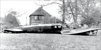  ?? Picture: Images of Ashford, by Mike Bennett ?? All German markings were quickly blacked out on the wreckage after the Heinkel hit the ground at Kennington