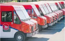  ?? GRAHAM HUGHES/CANADIAN PRESS FILES ?? Canada Post Group posted a $198-million net profit in 2014, compared to a $29-million net loss in 2013.