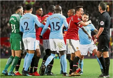  ?? — Reuters ?? What the Devil?: Manchester United’s Ander Herrera (third from right) remonstrat­ing with referee Michael Oliver before being shown a yellow card for simulation in the English Premier League match against Manchester City at Old Trafford on Sunday....