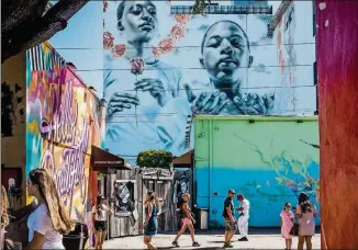  ?? ROSE MARIE CROMWELL/THE NEW YORK TIMES ?? Murals adorn walls of dozens of buildings in Miami’s Wynwood neighborho­od.