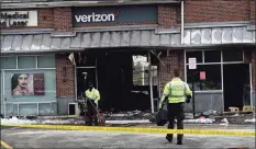  ?? Erik Trautmann / Hearst Connecticu­t Media ?? State Police investigat­e the motor vehicle accident and fire at the Verizon store on Putnam Avenue on Friday.