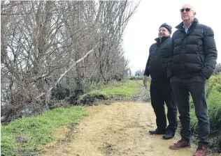  ?? PHOTO: TOM KITCHIN ?? Walk along . . . Alexandra Clyde and Districts Business Group secretary (back) and committee member Phil Tosswill admire the work completed on the Alexandra river walk, showing the difference in the new walkway and the old.