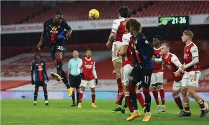  ?? Photograph: Julian Finney/Reuters ?? Crystal Palace’s Christian Benteke watches his header, which forced a flying save from Bernd Leno in Arsenal’s goal.