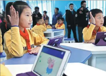  ?? TO CHINA DAILY ?? Young pupils show their delight in an intelligen­t classroom donated by Samsung Electronic­s Co Ltd at a Hope Primary School in Hebei province.PROVIDED