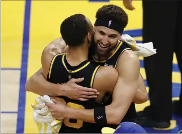  ?? JOHN HEFTI — THE ASSOCIATED PRESS ?? The Warriors' Klay Thompson, right, and Stephen Curry hug after beating the Mavericks in the Western Conference Finals.