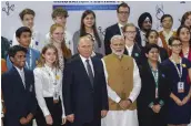  ?? — PTI ?? Prime Minister Narendra Modi and Russian President Vladimir Putin pose for photos with a group of Indian and Russian students in New Delhi on Friday.