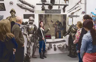  ??  ?? Weapons of mass entertainm­ent: A guide at the Weta Cave Workshop tours guests through the Armoury.