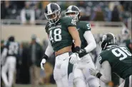  ?? AL GOLDIS - THE ASSOCIATED PRESS ?? Michigan State’s Kenny Willekes (48), Jack Saylor (54) and Jacub Panasiuk (96) warm up before an NCAA college football game against Maryland, Saturday, Nov. 30, 2019, in East Lansing, Mich.