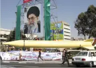  ??  ?? A military exhibition displays the Shahab-3 missile under a picture of the Iranian leader Ayatollah Ali Khamenei, in Tehran. (AP/file)