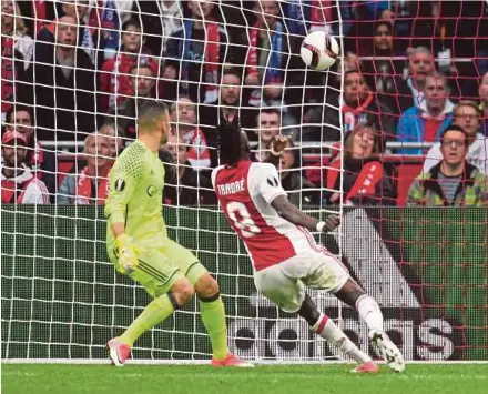  ?? REUTERS PIC ?? Ajax’s Bertrand Traore scores their fourth goal against Lyon in the Europa League semi-final on Wednesday. Ajax won 4-1.