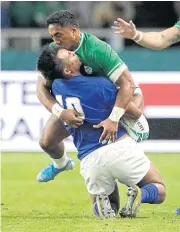  ?? AP ?? Ireland’s Bundee Aki, right, tackles Samoa’s Ulupano Seuteni.
