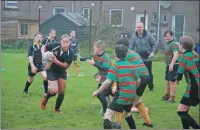  ?? 06_a44rugby20 ?? In the P6/7 competitio­n, Mid Argyll’s Aileen Barr has a go with ball in hand.
