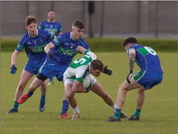  ??  ?? Avondale’s Callum Pursey comes under serious pressure from the AGB defence during the JBFC semi-final in Aughrim last weekend.