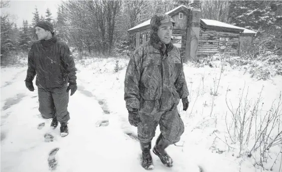  ?? FILE ?? Local firefighte­rs Craig MacNeil, right and Allan Trimm, volunteere­d to join the search for missing James Delorey, 7, of South Bar, on Dec. 6, 2009.