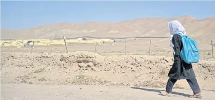  ?? AFP ?? An Afghan girl returns to her home after attending school in Chashma Dozak area of Badghis province on Saturday.