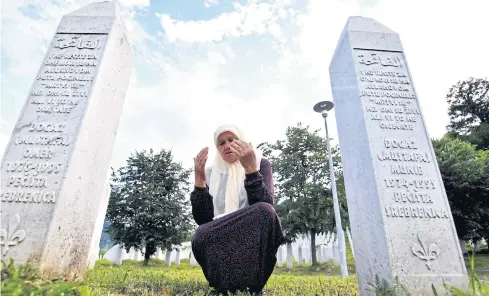  ??  ?? ONLY MEMORIES LEFT: A Bosnian Muslim woman, a survivor of the Srebrenica 1995 massacre, prays between her sons’ tombstones at Potocari memorial centre near Srebrenica, Bosnia, last week.