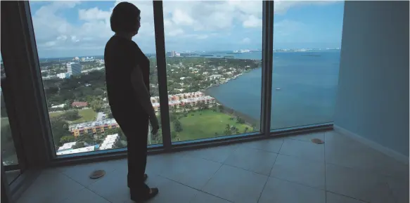  ?? CITIZEN NEWS SERVICE PHOTO BY LYNNE SLADKY ?? A prospectiv­e buyer looks at the view from The Blue condominiu­m in Miami in 2010. A house with a fabulous view can be hard for a homebuyer to resist.