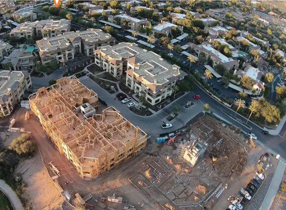  ??  ?? THE LONG VIEW Arsenault and Wells have built a 20-year partnershi­p investing in and constructi­ng apartments, townhouses, and resorts like the Corriente Condos in Scottsdale, Arizona (below). Completed in 2015, it boasts eight buildings with a total of...