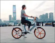  ?? PROVIDED TO CHINA DAILY ?? A user of a Mobike electric bike in Shanghai.