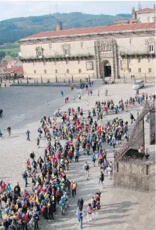  ??  ?? German pilgrims arrive in the cathedral square of Santiago de Compostela, the endpoint of the Camino de Santiago.