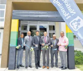  ?? CONTRIBUTE­D ?? Prime Minister Andrew Holness (third right), officially opens phase one of the Ruthven Towers apartment complex, which was developed by the National Housing Trust (NHT), on Wednesday. Also participat­ing in the ribbon-cutting exercise are (from left) Mayor of Kingston, Senator Councillor Delroy Williams; NHT Chairman, Lennox Channer; Ruthven Towers homeowner, Kirk Frankson; NHT Senior General Manager, Donald Moore; and Member of Parliament for St Andrew South Eastern, Julian Robinson.