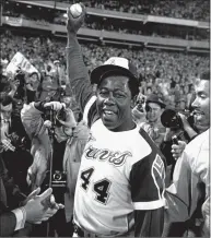  ?? Bob Daugherty / Associated Press ?? Hank Aaron holds the ball he hit for his 715th career home run on April 8, 1974, in Atlanta Stadium.