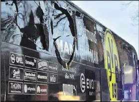  ?? MARTIN MEISSNER / ASSOCIATED PRESS ?? A window of the Borussia Dortmund soccer team’s bus is damaged after an explosion April 11. The suspect made “suspicious options purchases” for shares in the team the same day as the attack, officials said.