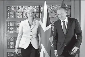  ?? AP/GEERT VANDEN WIJNGAERT ?? British Prime Minister Theresa May walks with European Council President Donald Tusk before a meeting Friday in Brussels. The European Union exit talks haven’t “been easy for either side,” May said.