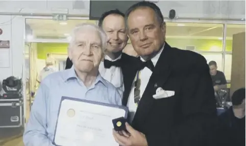  ??  ?? Jack Hood is presented with the Paul Harris Fellowship by Peter Haydn Jones, president of Rotary Club of Chichester Priory, in 2015